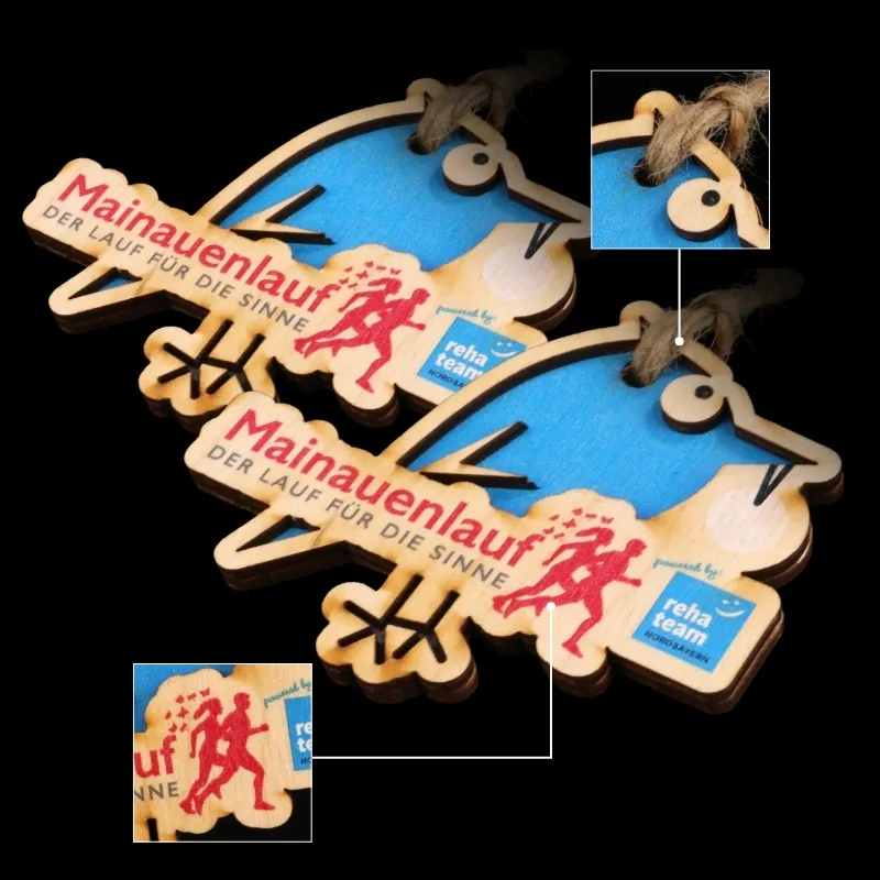 Wooden cut-out medals with colorful designs for sports events.