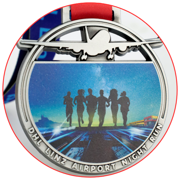 Medal featuring runners and an aeroplane, designed for the DHL Linz Airport Night Run.