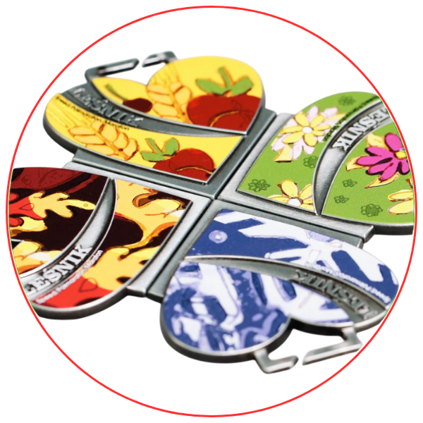 Set of four interconnected medals representing the four seasons with colourful designs.