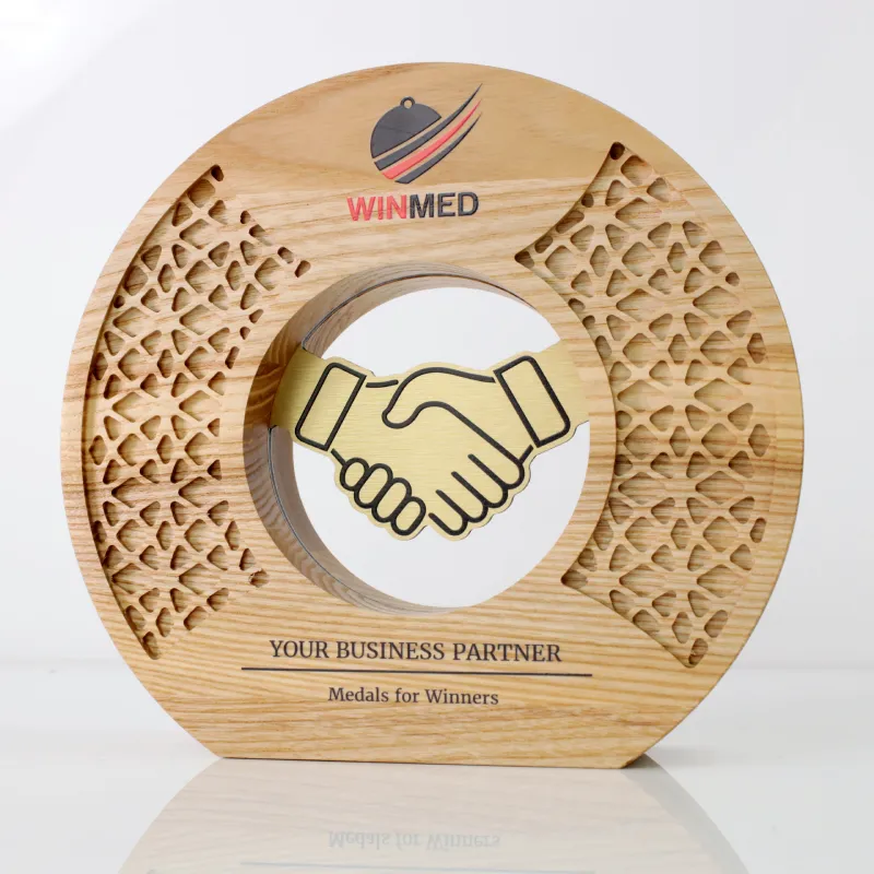 A custom wooden award with a handshake design and the slogan 'Your Business Partner - Medals for Winners' engraved.