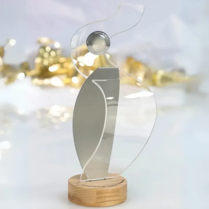 An artistic award made of acrylic and wood with a unique, flowing design, perfect for modern recognition ceremonies.