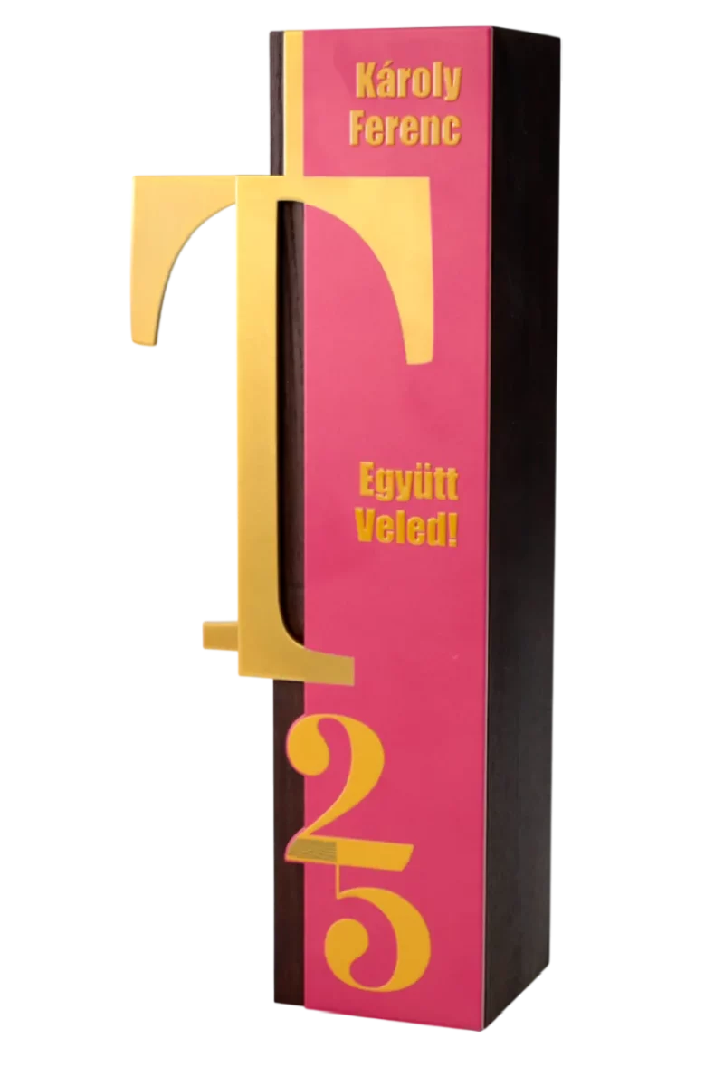 A finished custom award for a 25th anniversary, made of wood and featuring gold and pink accents with 'Károly Ferenc' engraved.